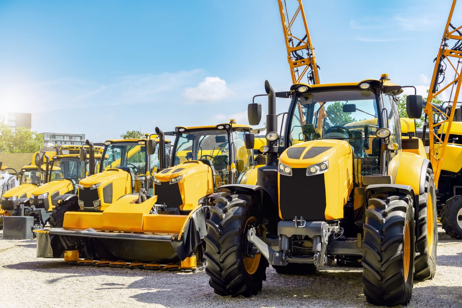 Heavy equipment lined up at a dealer lot
